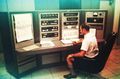 “Yours truly” operating the Communications Console. Note the Bermuda shorts.